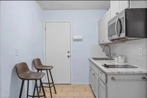 a en suite bathroom with a sink and a mirror