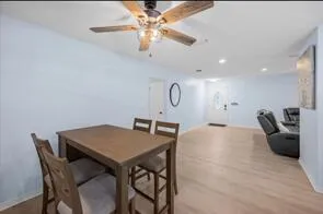a kitchen with refrigerator and chairs