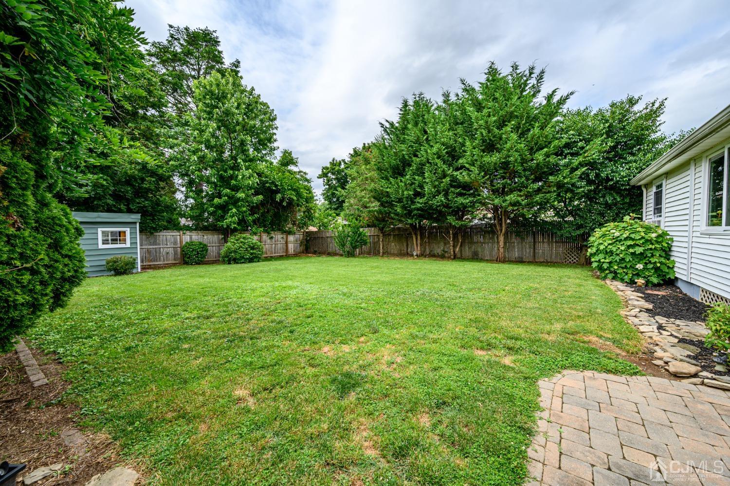 217 Clamer Road Ewing, NJ 08628 - Photo 26 of 29 a backyard of a house with plants and large tree