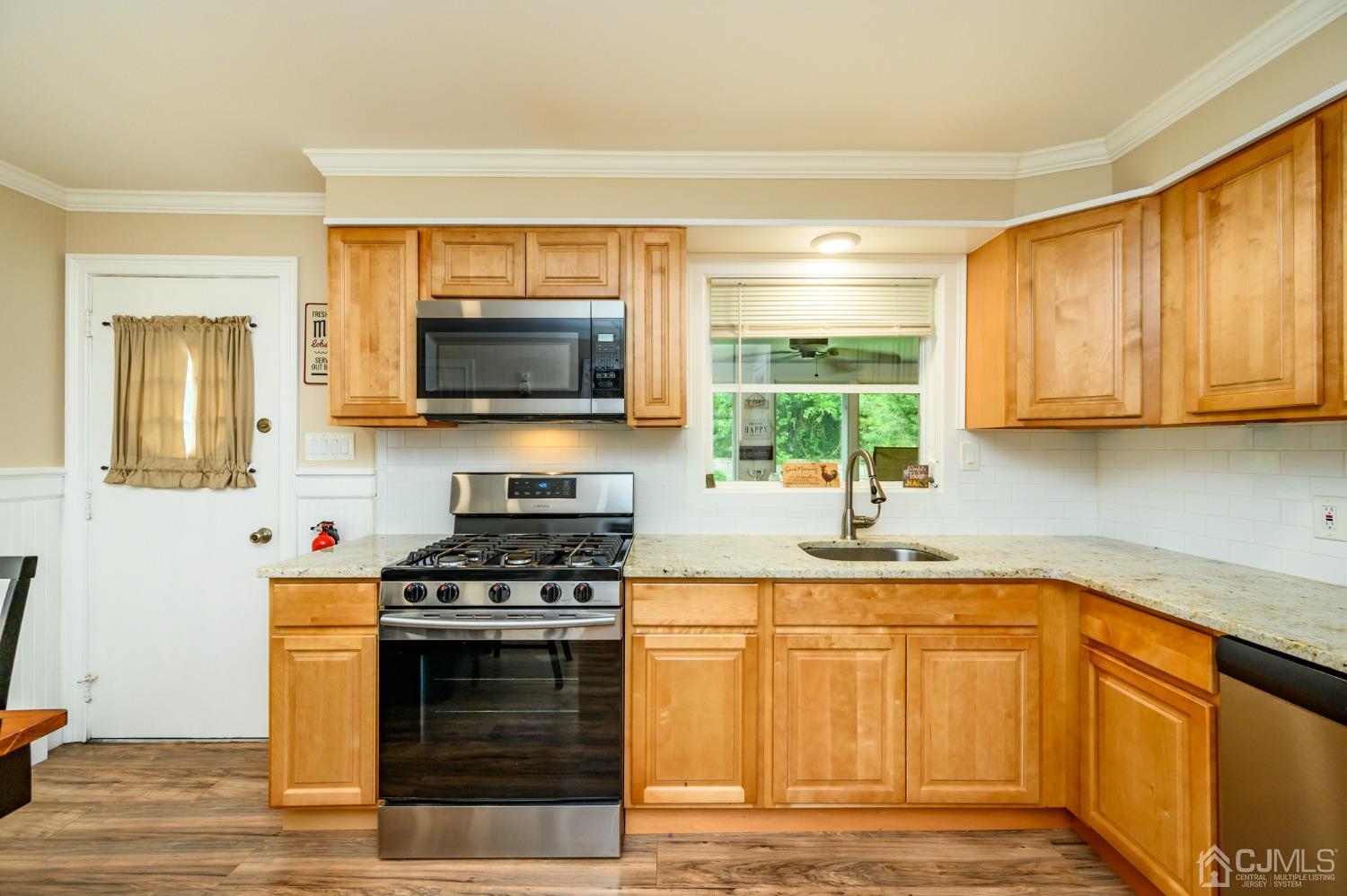 217 Clamer Road Ewing, NJ 08628 - Photo 10 of 29 a kitchen with granite countertop a stove and a sink