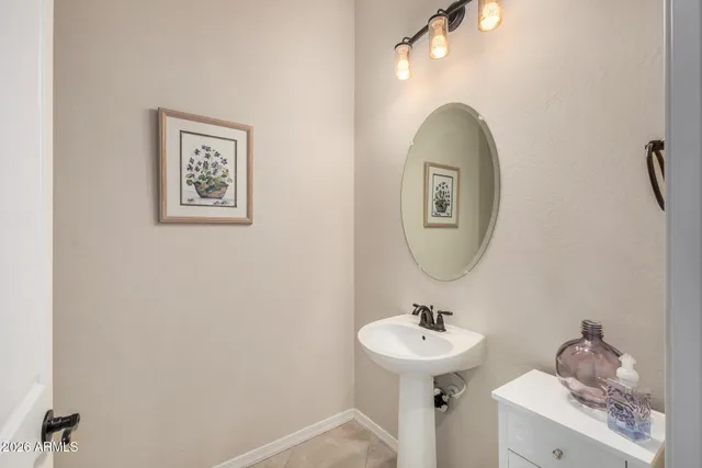 a spacious bathroom with a granite countertop sink mirror and shower