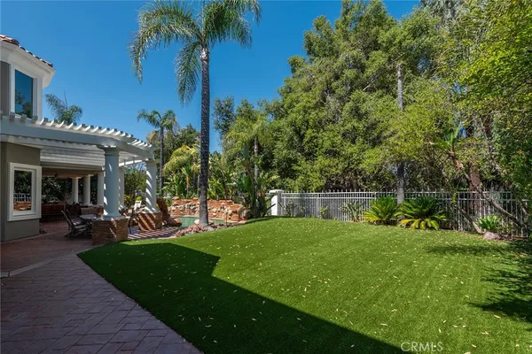 a view of a house with a backyard porch and sitting area
