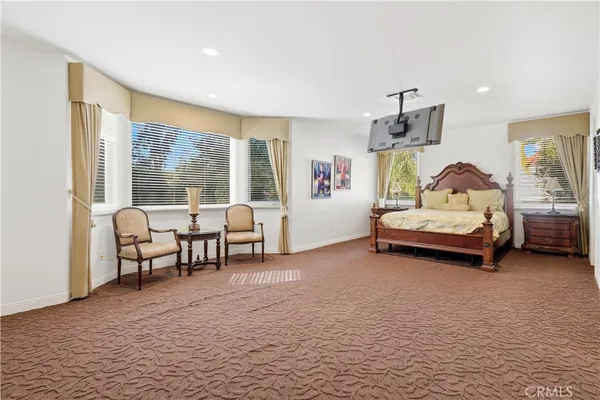 a bedroom with furniture and a large window