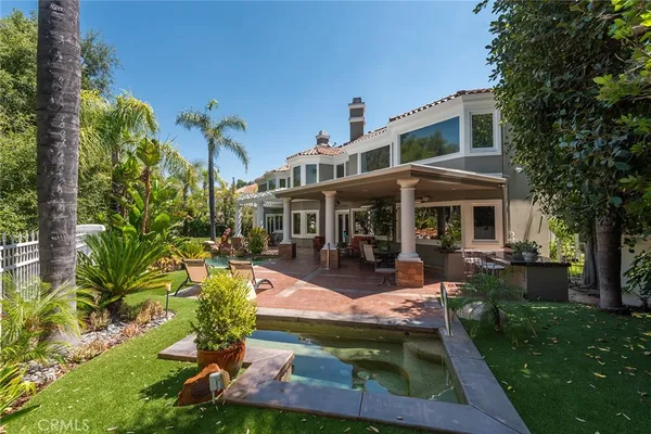 a view of a house with backyard porch and sitting area