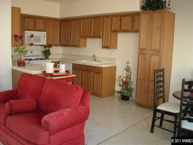 2150 Stanhope Lane Reno, NV 89502 - Photo 3 of 13 a kitchen with stainless steel appliances kitchen island granite countertop a refrigerator and a sink