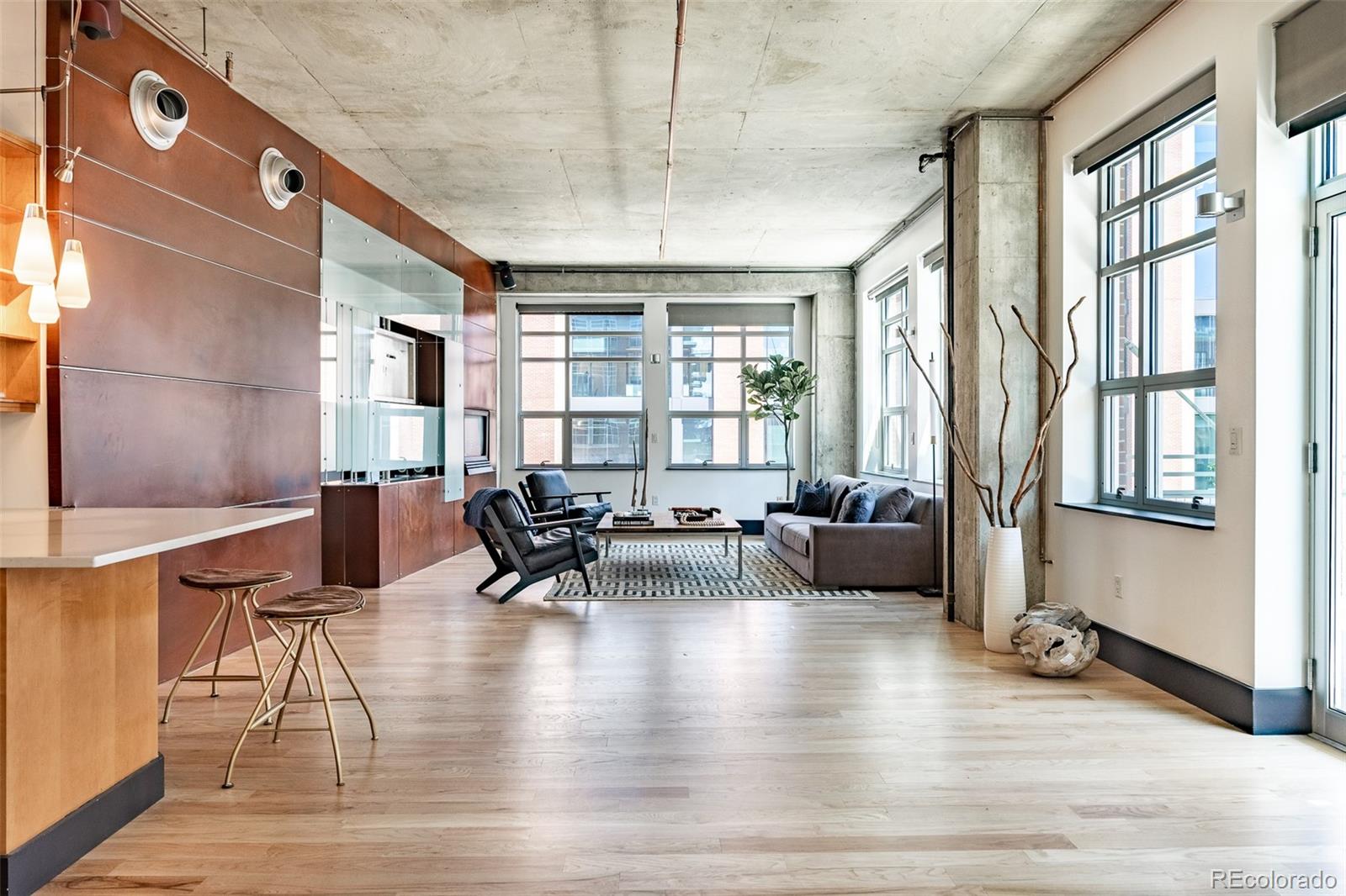 1890 Wynkoop Street, Unit 604 Denver, CO 80202 - Photo 12 of 26 a living room with fireplace furniture and a large window