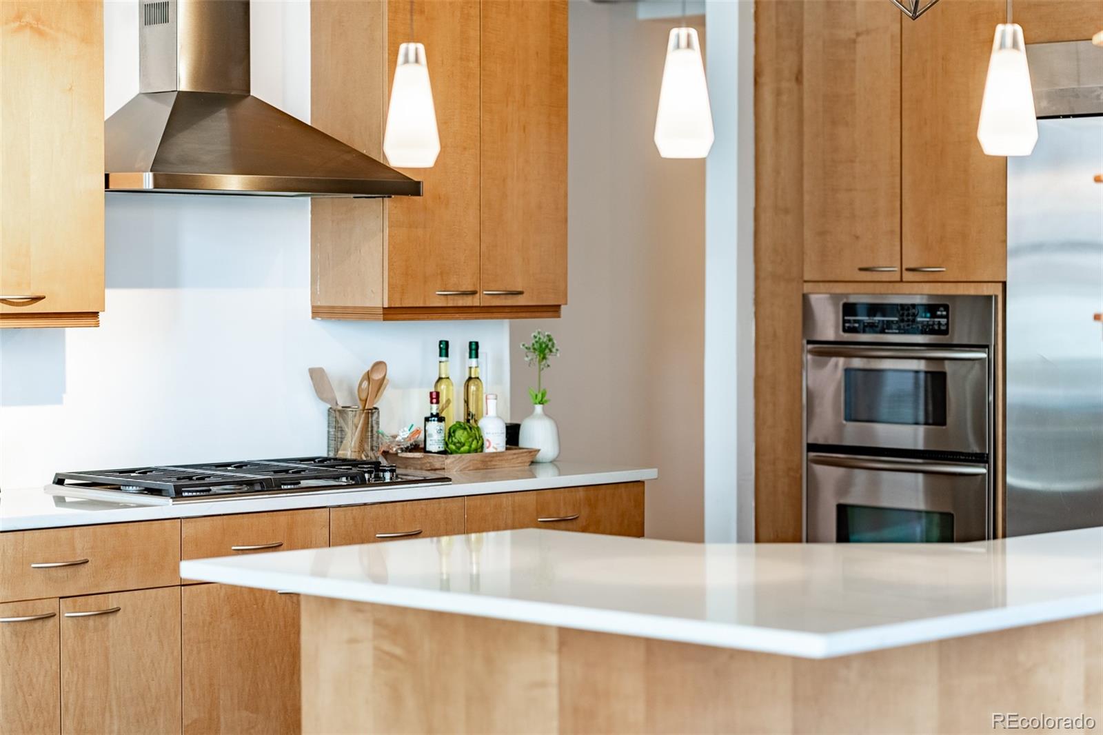 1890 Wynkoop Street, Unit 604 Denver, CO 80202 - Photo 15 of 26 a kitchen with stainless steel appliances a sink a stove and a refrigerator