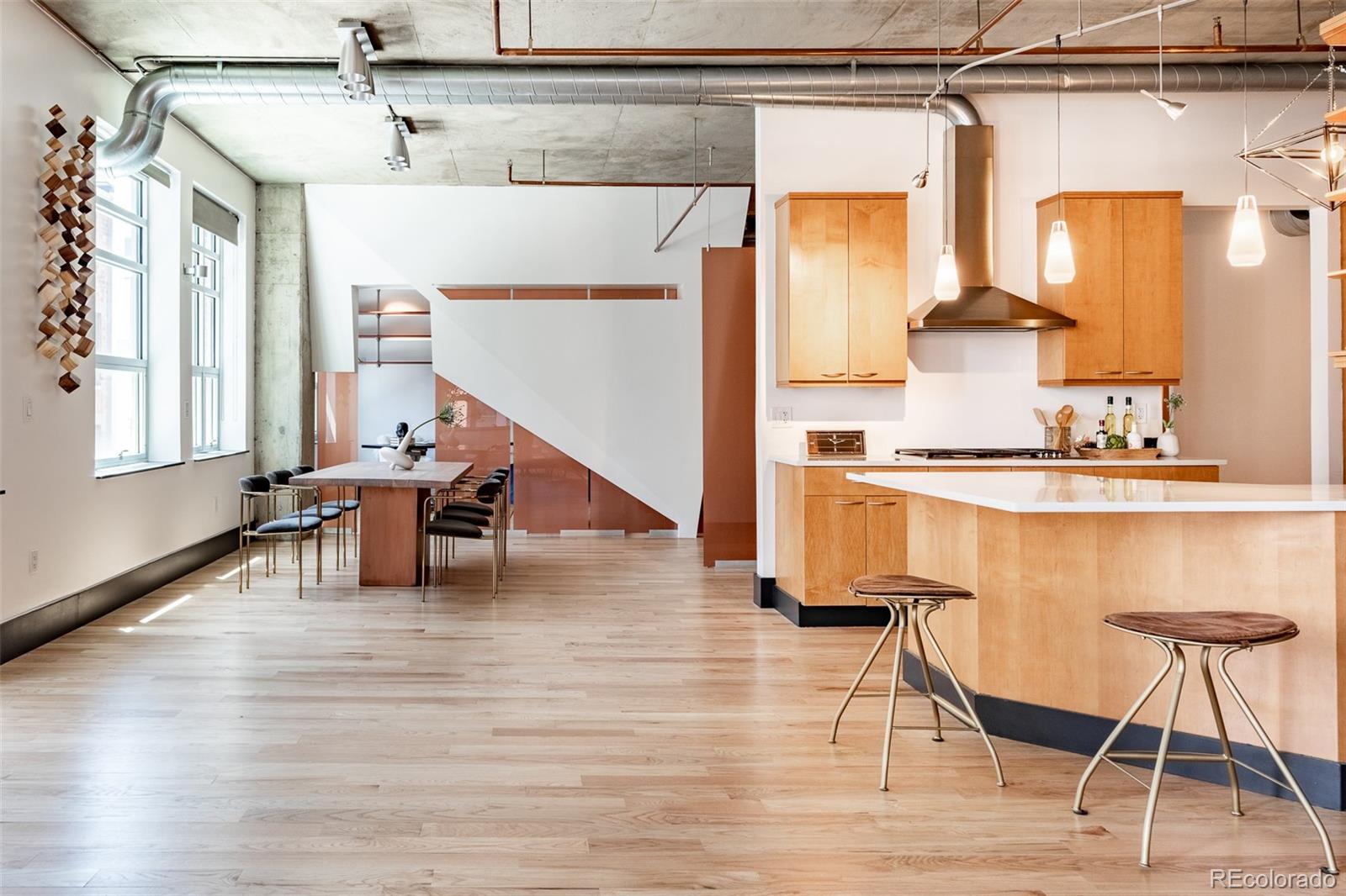 1890 Wynkoop Street, Unit 604 Denver, CO 80202 - Photo 17 of 26 a living room with table and chairs