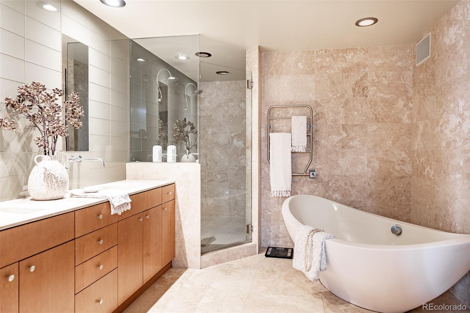 1890 Wynkoop Street, Unit 604 Denver, CO 80202 - Photo 23 of 26 a bathroom with a tub sink shower and mirror