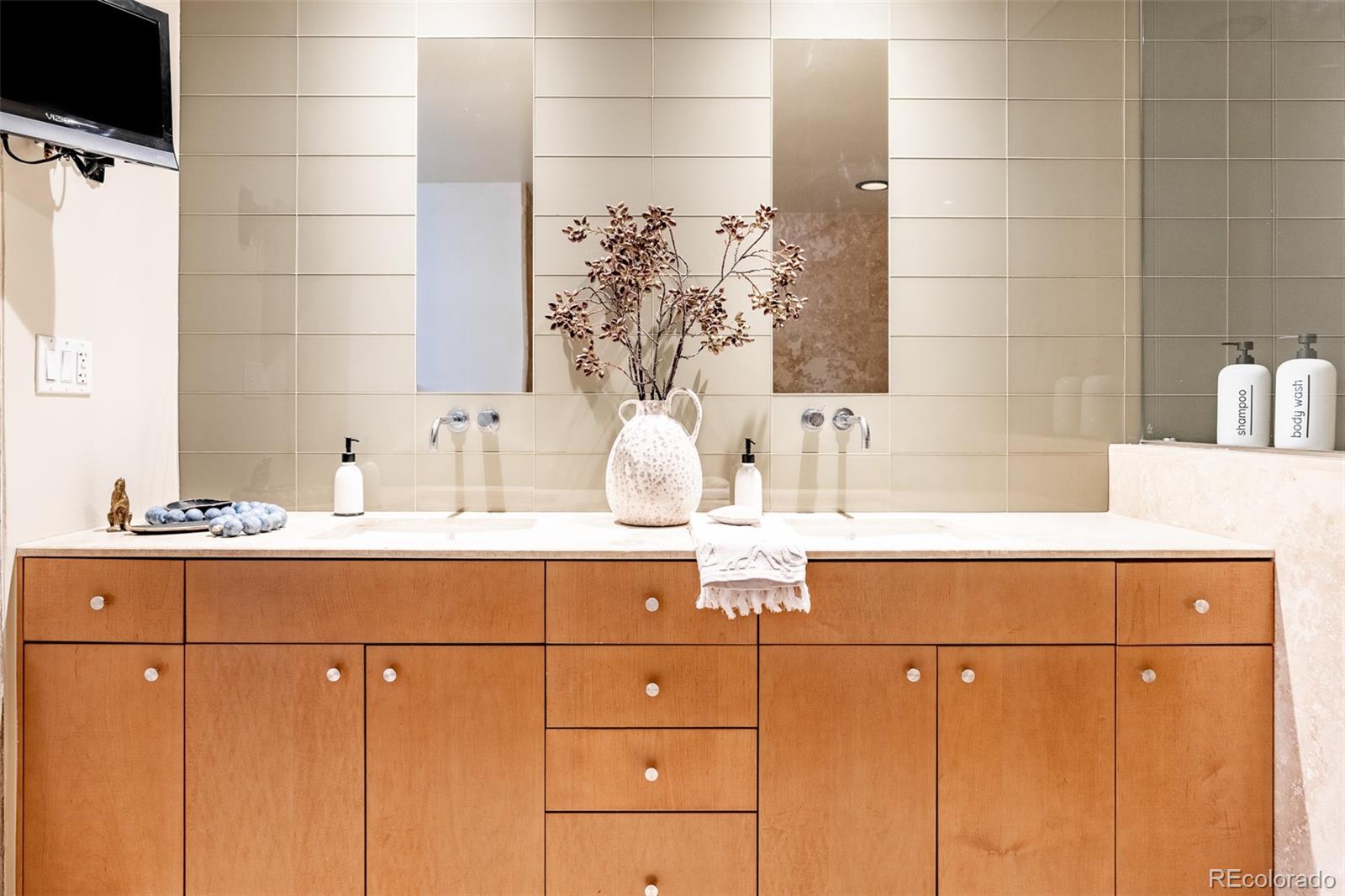 1890 Wynkoop Street, Unit 604 Denver, CO 80202 - Photo 24 of 26 a bathroom with a sink and mirror