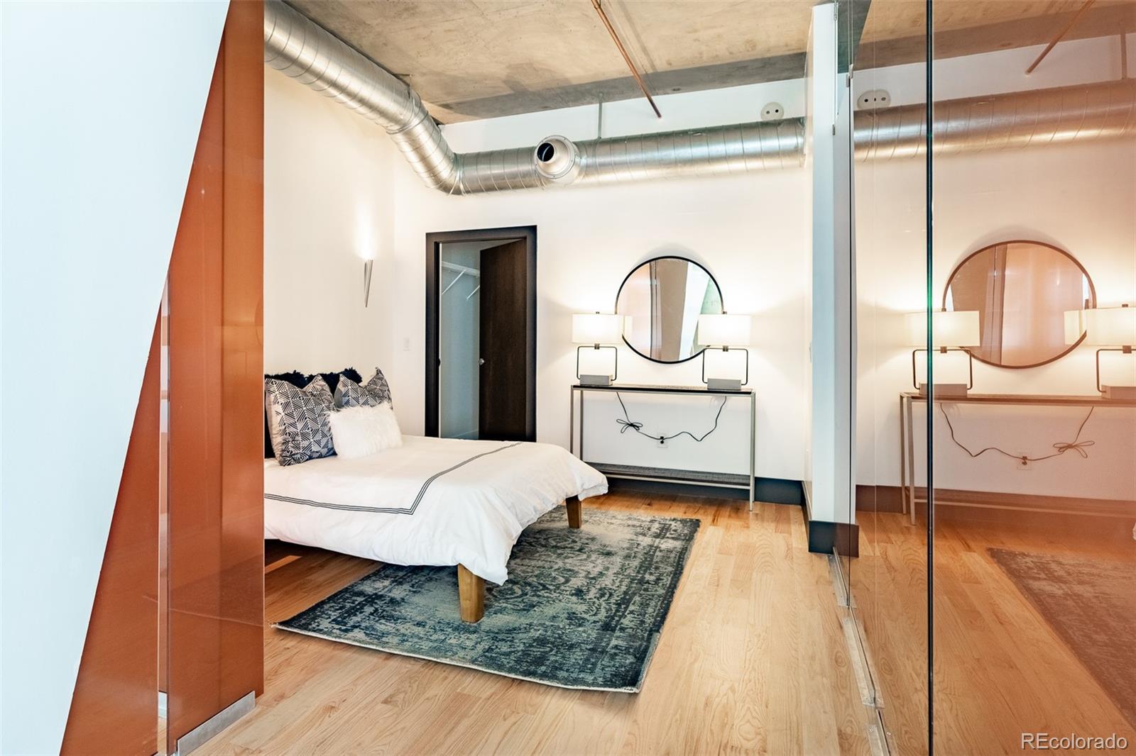 1890 Wynkoop Street, Unit 604 Denver, CO 80202 - Photo 7 of 26 a spacious bedroom with a bed and a large window