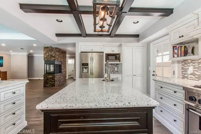 a kitchen with stainless steel appliances granite countertop a stove and cabinets