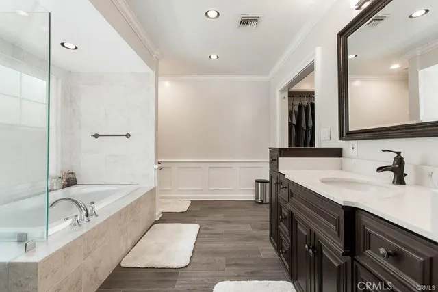 a bathroom with a tub sink and mirror