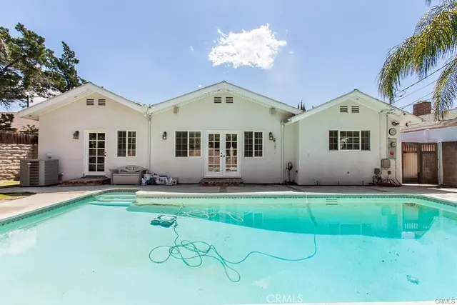 a backyard of a house with table and chairs