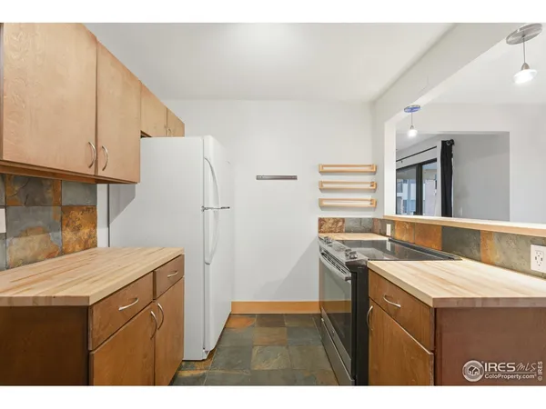 a kitchen with refrigerator cabinets and a sink