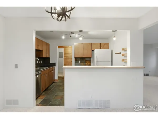 a kitchen with a refrigerator and a sink
