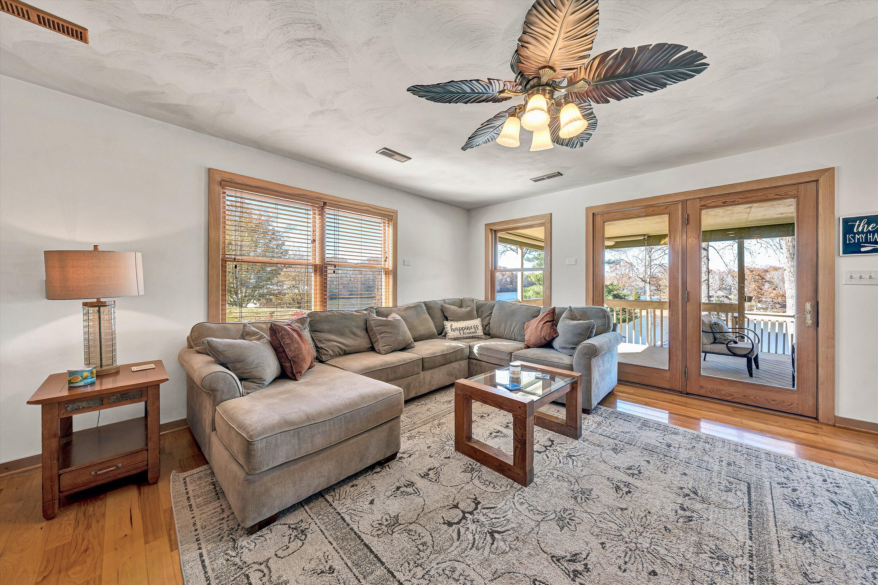290 Winding Way Union Hall, VA 24176 - Photo 12 of 50 a living room with furniture a chandelier and a large window