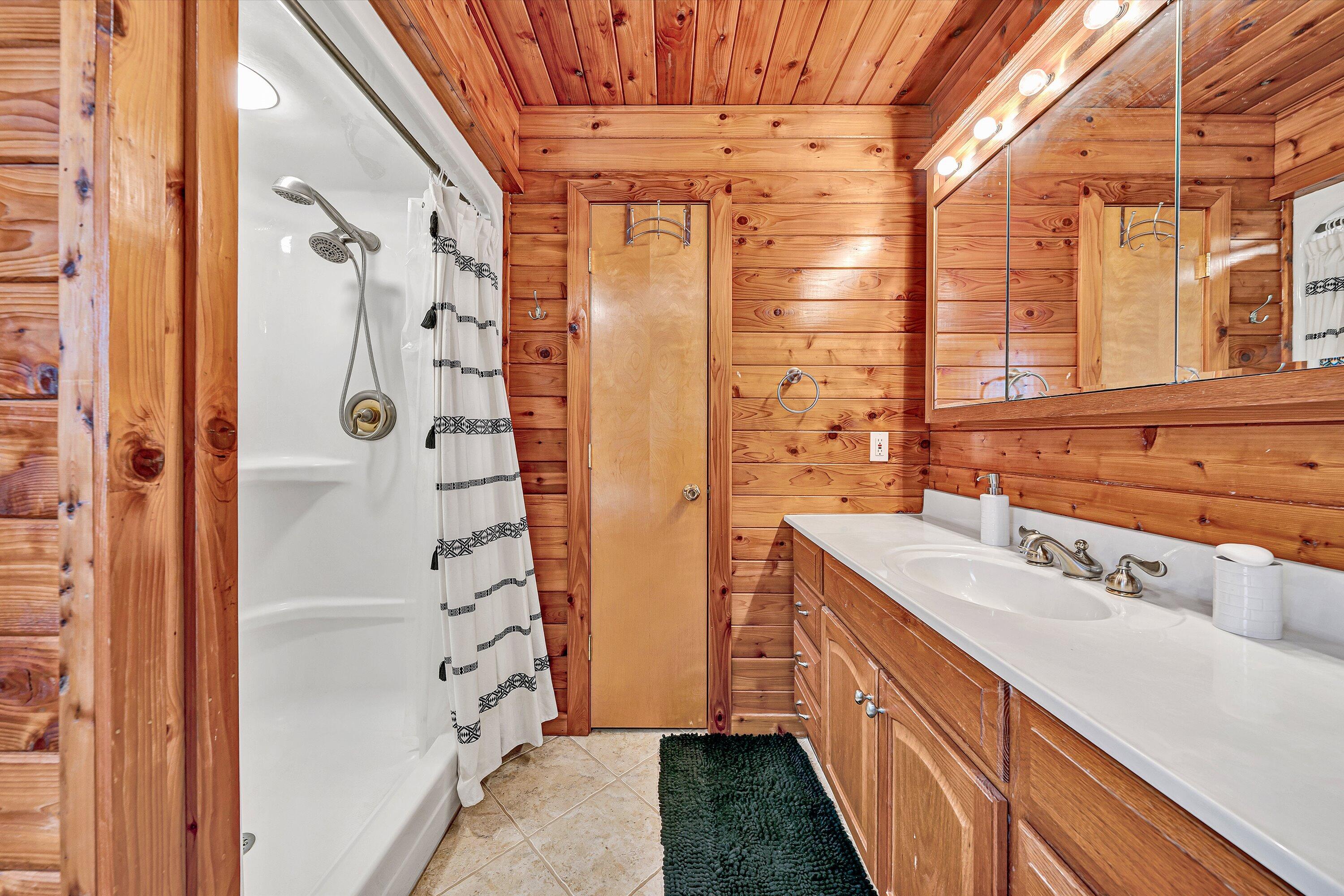 290 Winding Way Union Hall, VA 24176 - Photo 37 of 50 a bathroom with a double vanity sink a large mirror and shower