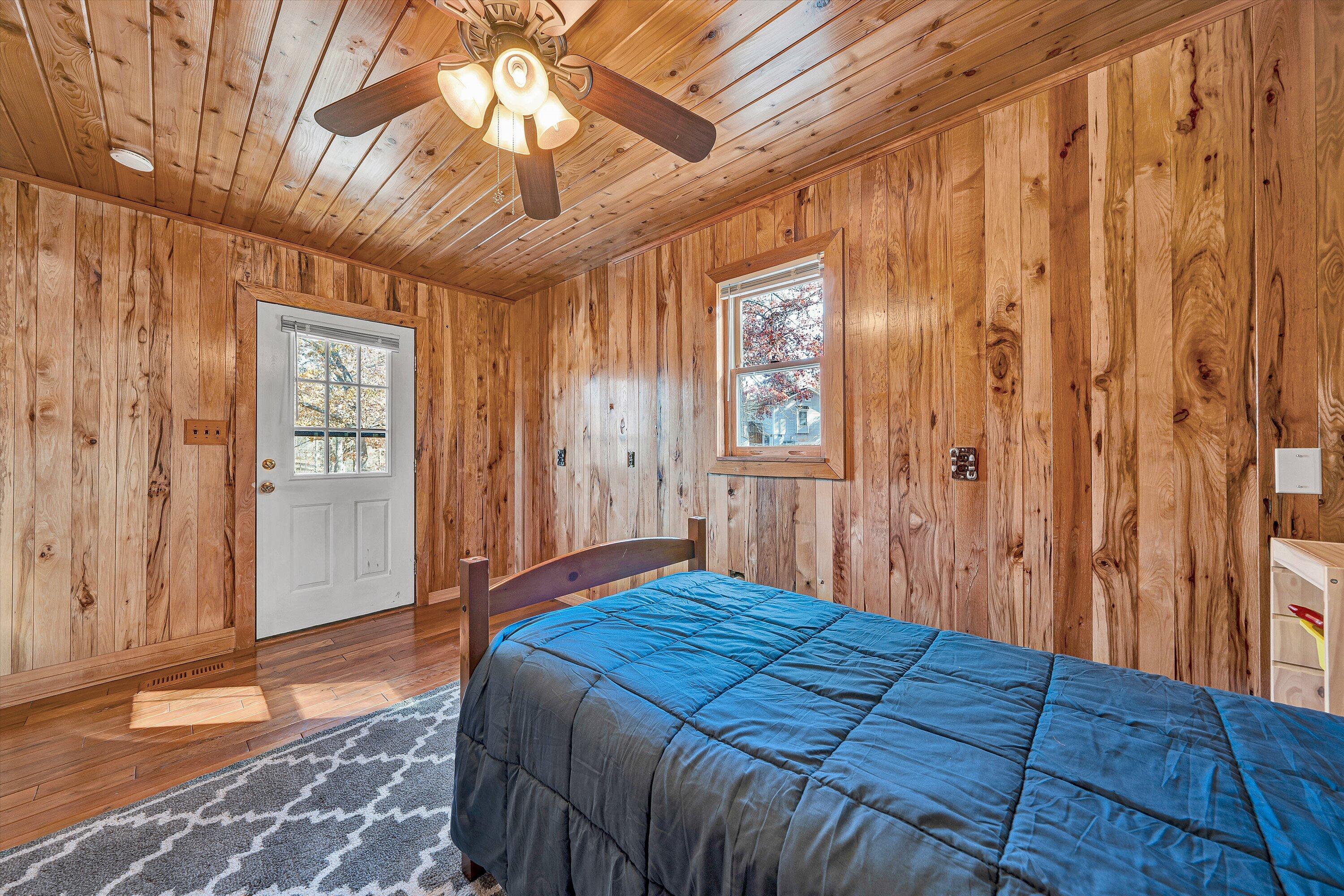 290 Winding Way Union Hall, VA 24176 - Photo 44 of 50 a bedroom with a large bed and a chandelier