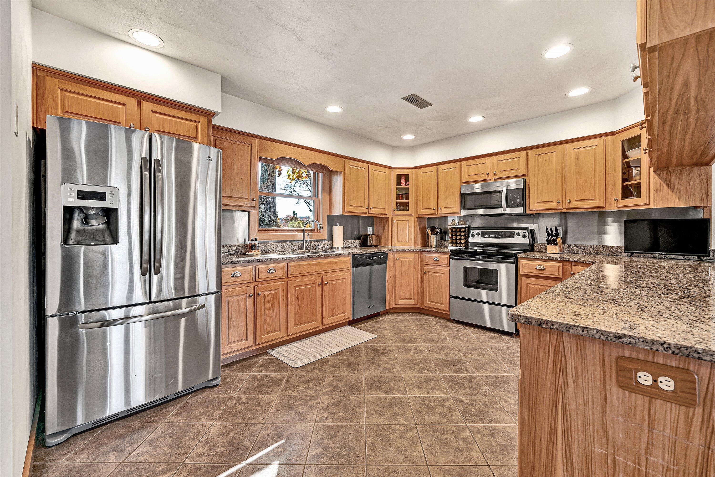 290 Winding Way Union Hall, VA 24176 - Photo 7 of 50 a kitchen with granite countertop stainless steel appliances a refrigerator sink and microwave