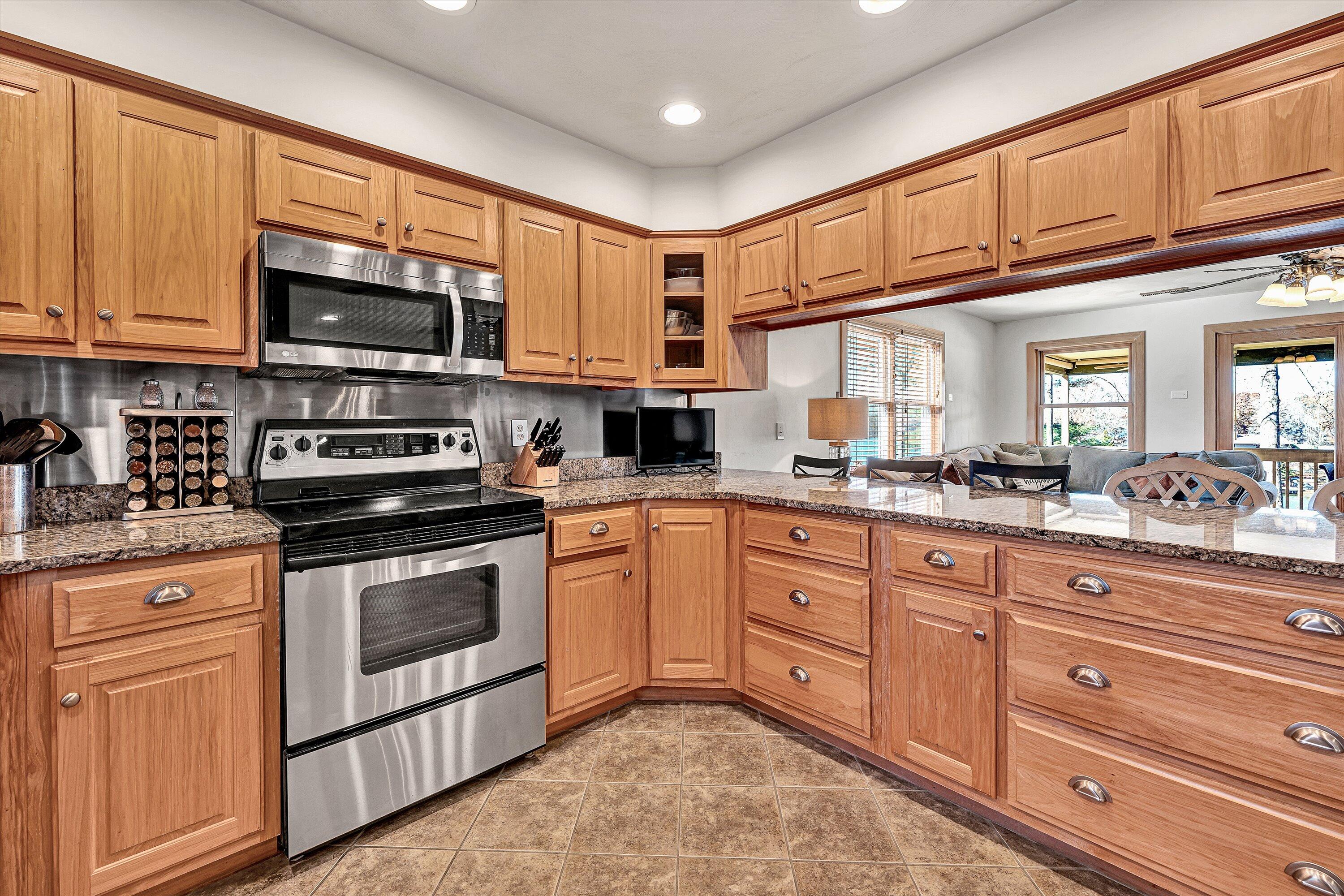 290 Winding Way Union Hall, VA 24176 - Photo 9 of 50 a kitchen with stainless steel appliances granite countertop a stove sink microwave and cabinets