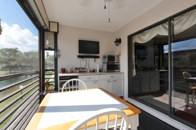a kitchen with a appliances a sink and cabinets