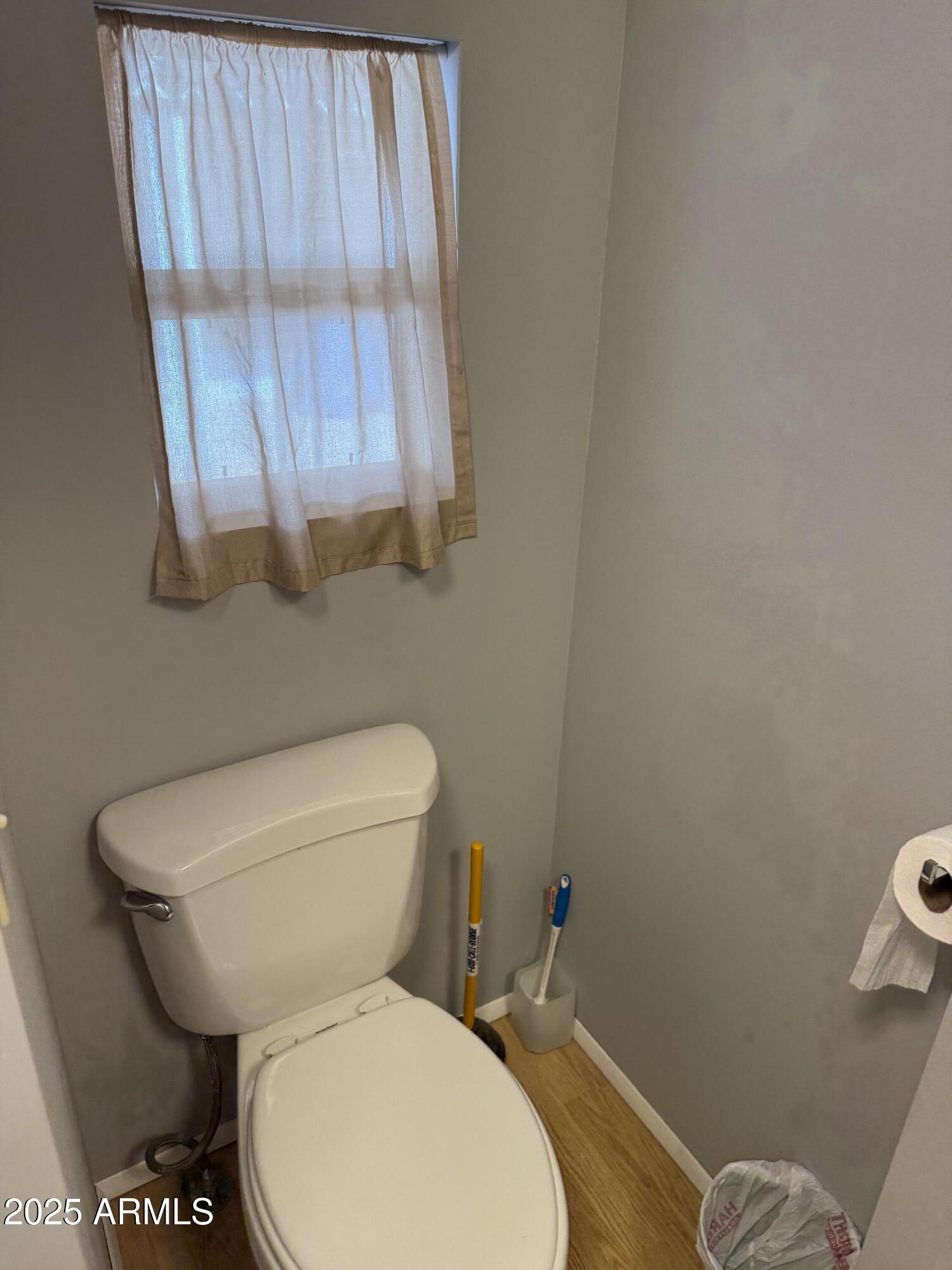 301 South Signal Butte Road, Unit FRNT Apache Junction, AZ 85120 - Photo 13 of 38 a white toilet sitting next to a shower curtain