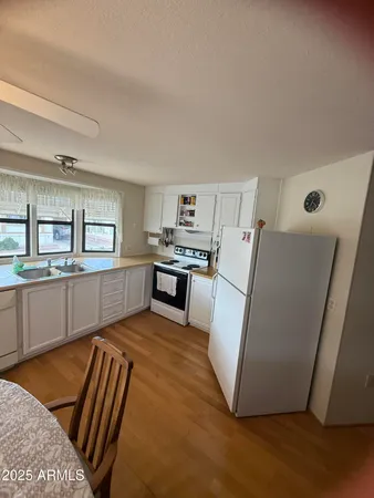a view of a dining room with furniture and a kitchen