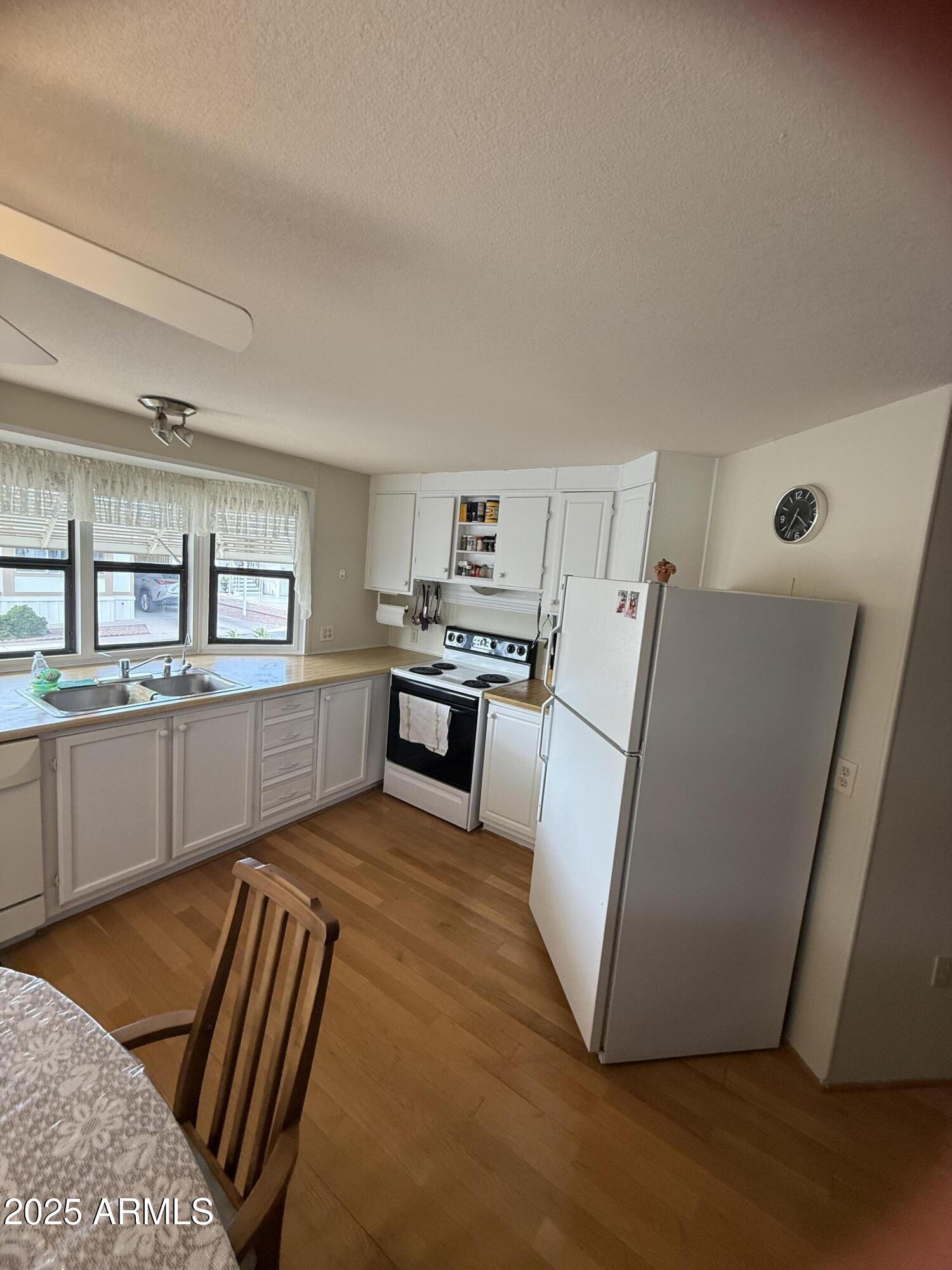 301 South Signal Butte Road, Unit FRNT Apache Junction, AZ 85120 - Photo 28 of 38 a kitchen with stainless steel appliances granite countertop a refrigerator sink and cabinets