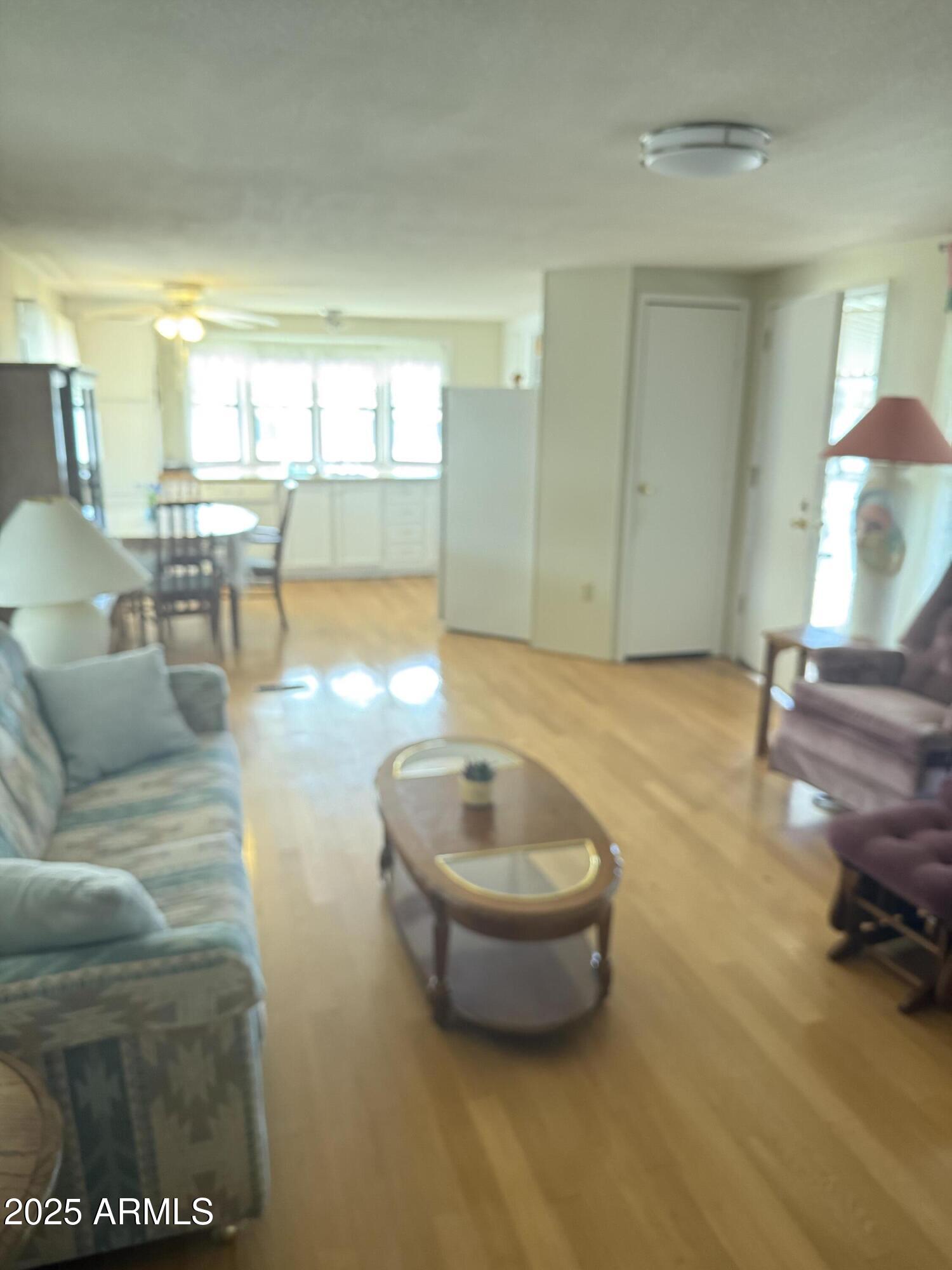 301 South Signal Butte Road, Unit FRNT Apache Junction, AZ 85120 - Photo 31 of 38 a living room with furniture and a wooden floor