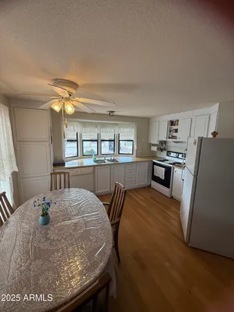 a view of a dining room with furniture and a kitchen
