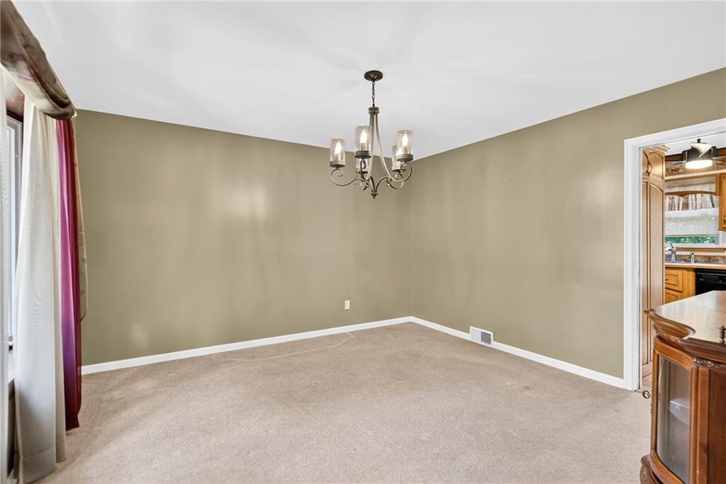 1705 Hassam Road Moon Township, PA 15108 - Photo 12 of 36 a view of a room with a hanging light and hardwood