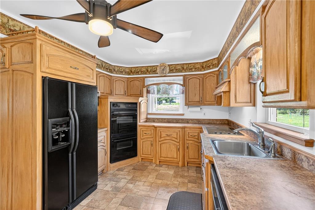 1705 Hassam Road Moon Township, PA 15108 - Photo 16 of 36 a kitchen with stainless steel appliances granite countertop a sink a stove and a refrigerator