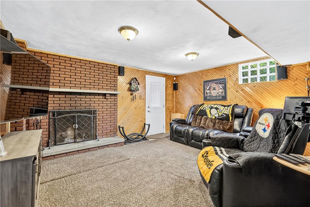 1705 Hassam Road Moon Township, PA 15108 - Photo 32 of 36 a living room with furniture a fireplace and a flat screen tv
