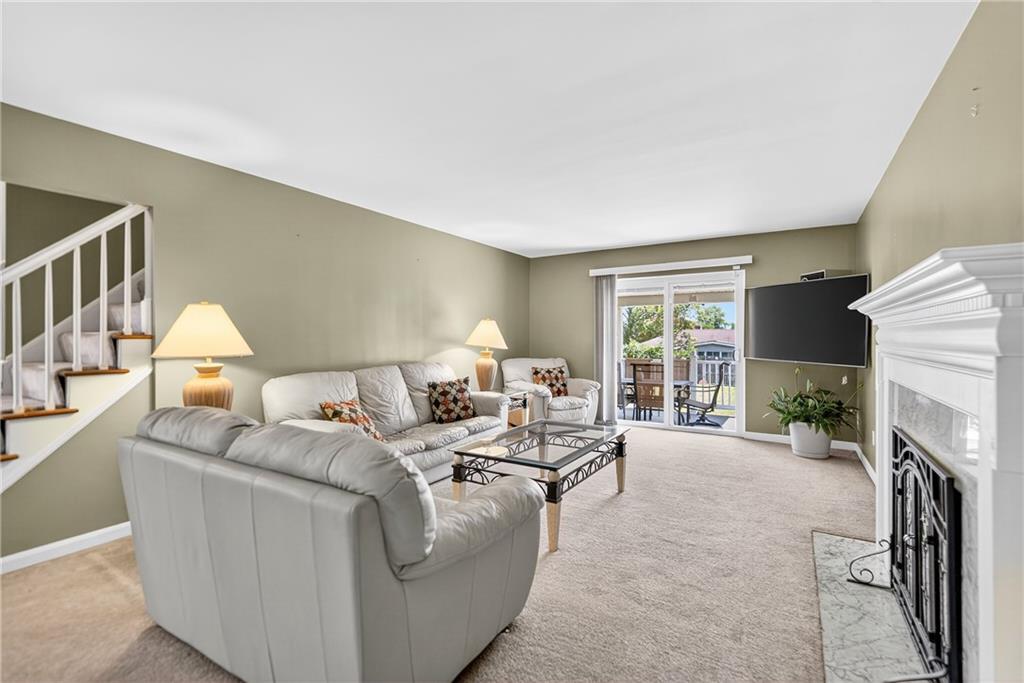 1705 Hassam Road Moon Township, PA 15108 - Photo 7 of 36 a living room with furniture a fireplace and a flat screen tv