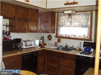 841 Avon Road Philadelphia, PA 19116 - Photo 2 of 12 a kitchen with sink cabinets and window