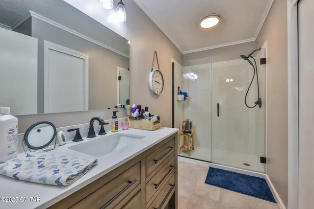 a bathroom with a granite countertop sink mirror toilet and shower