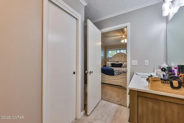 a bedroom with furniture and a potted plant