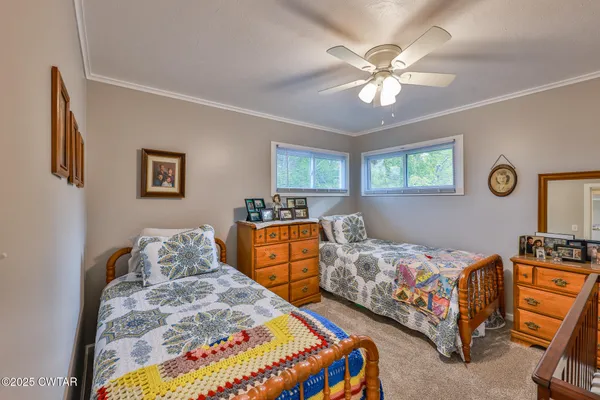 a bedroom with two beds and window