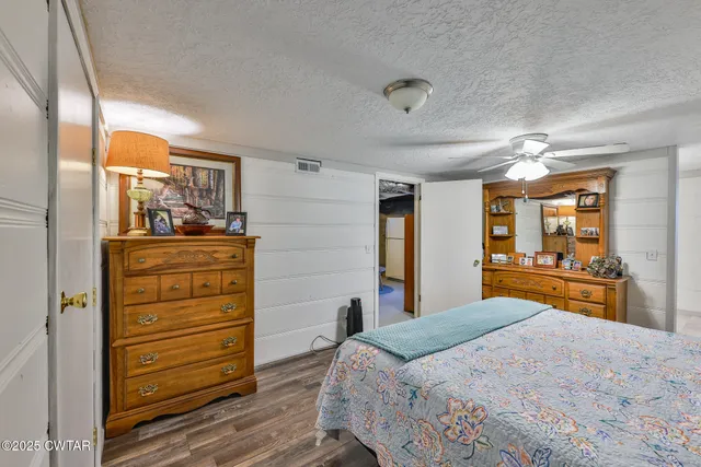 a bedroom with a bed and a dresser