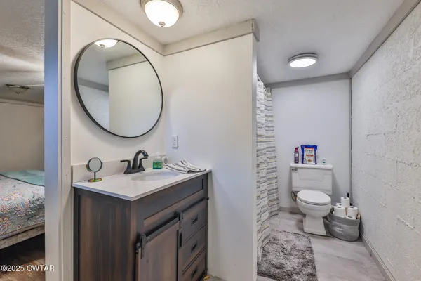 a bathroom with a toilet sink and mirror