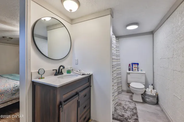 a bathroom with a toilet sink and mirror