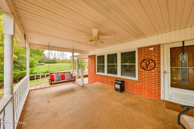 a view of a porch with wooden floor and iron stairs