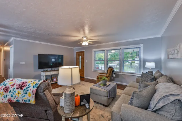 a living room with furniture and flat screen tv