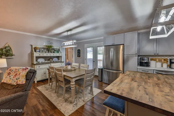 a kitchen with stainless steel appliances granite countertop a sink refrigerator and microwave