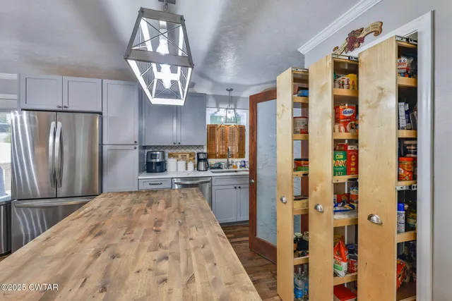 a kitchen with refrigerator and window