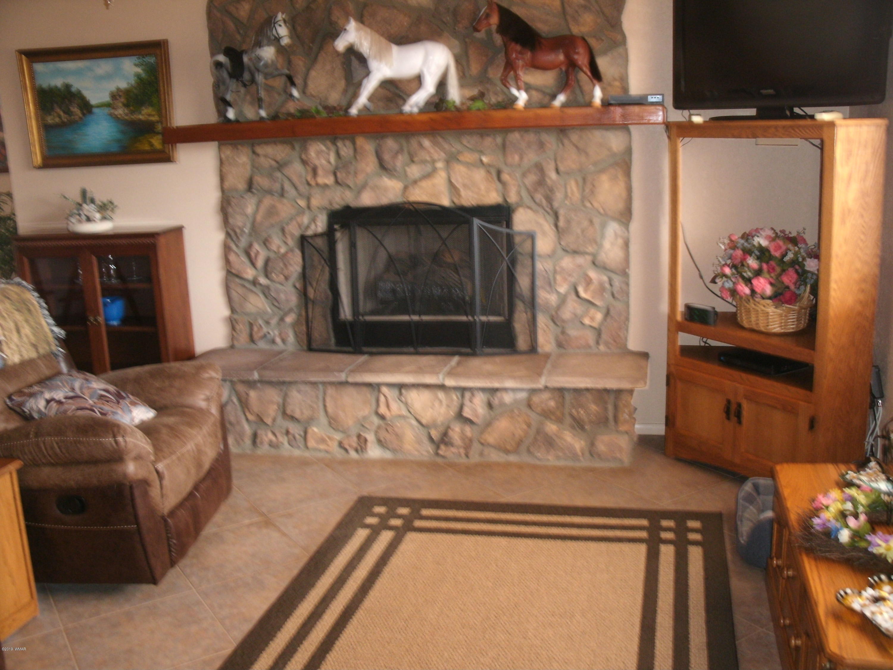 4078 East Pinto Road Snowflake, AZ 85937 - Photo 17 of 49 a living room with furniture and a fireplace
