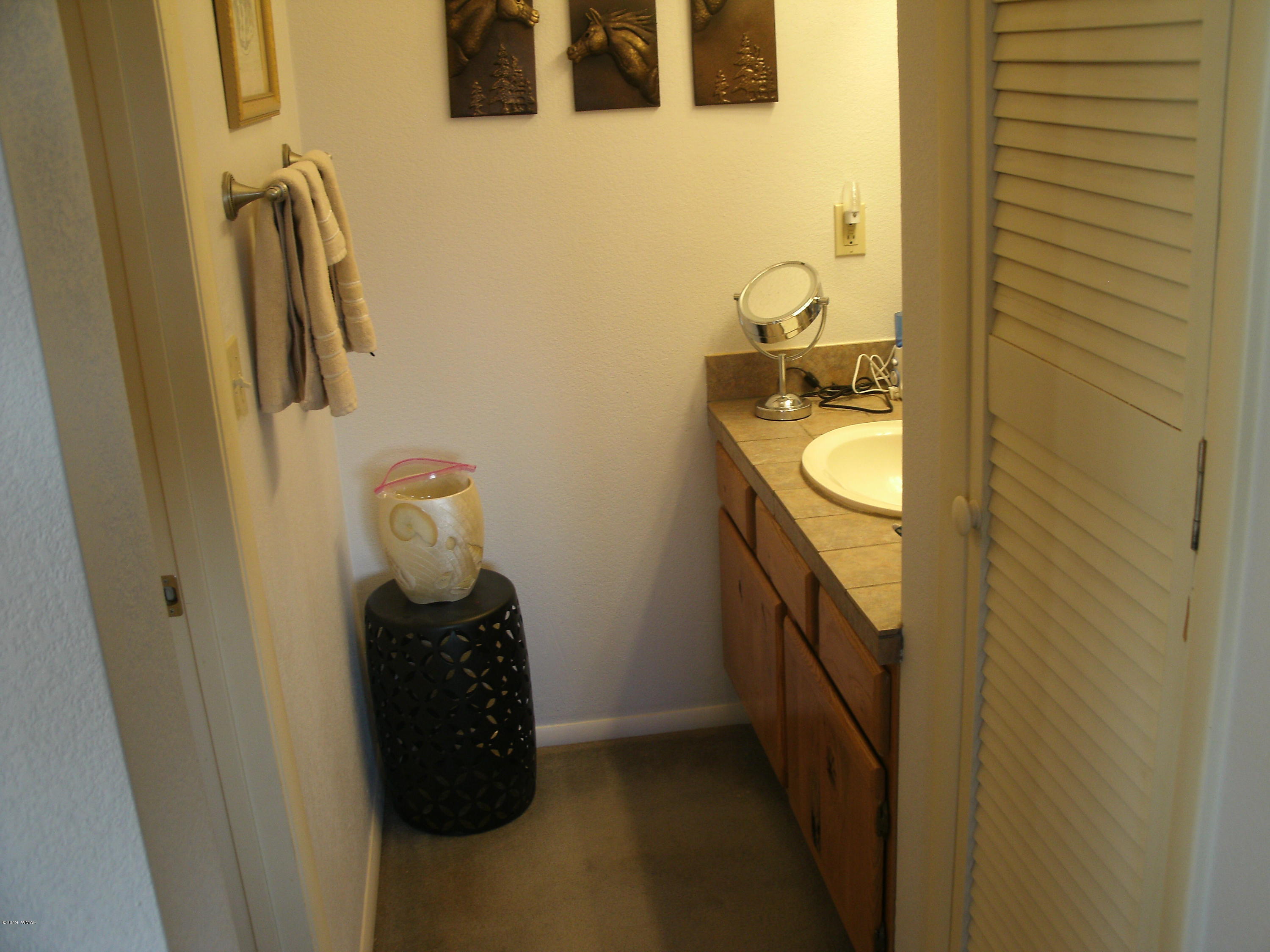 4078 East Pinto Road Snowflake, AZ 85937 - Photo 30 of 49 a bathroom with a sink and mirror