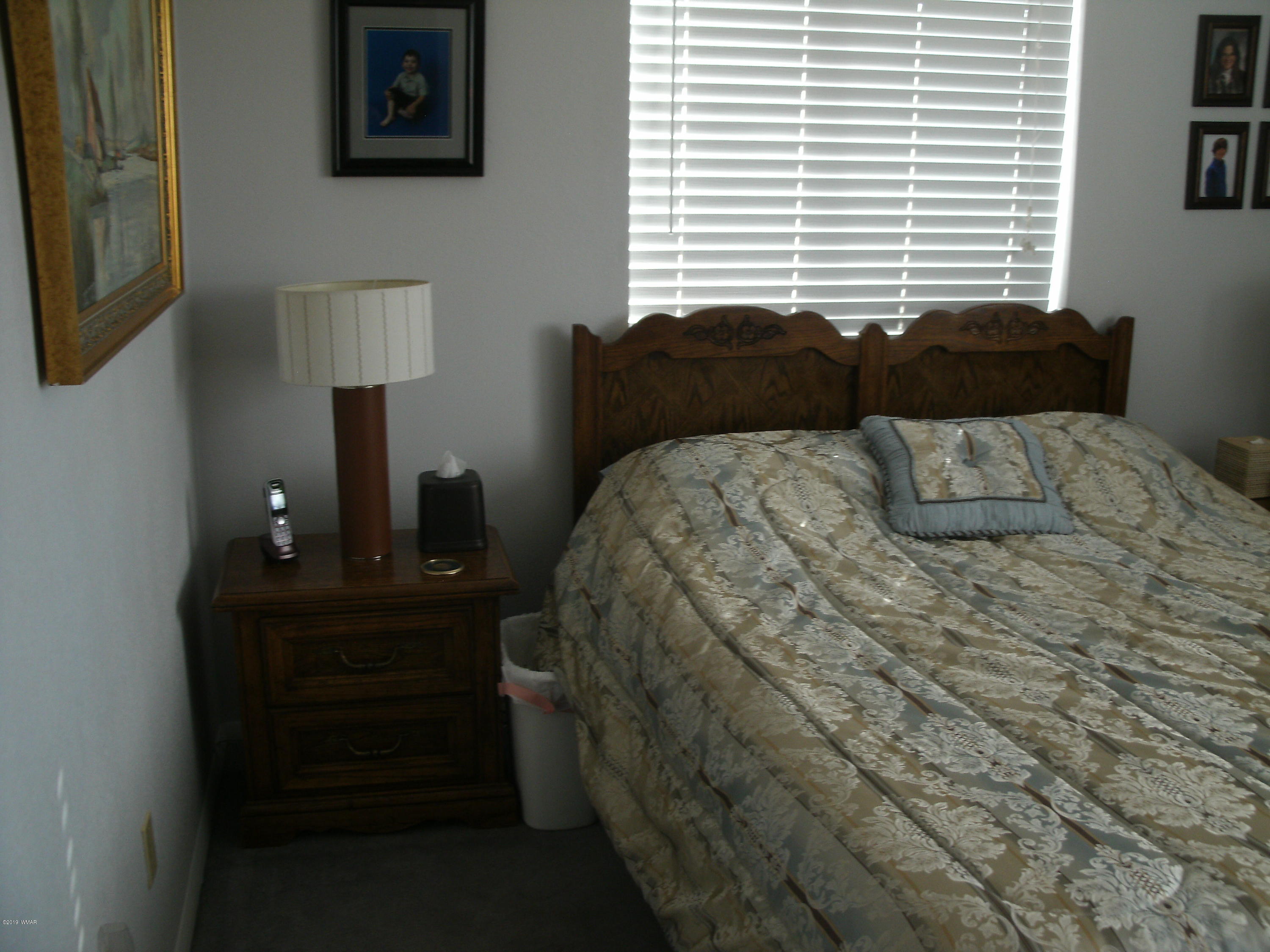 4078 East Pinto Road Snowflake, AZ 85937 - Photo 35 of 49 a bedroom with a bed window and table