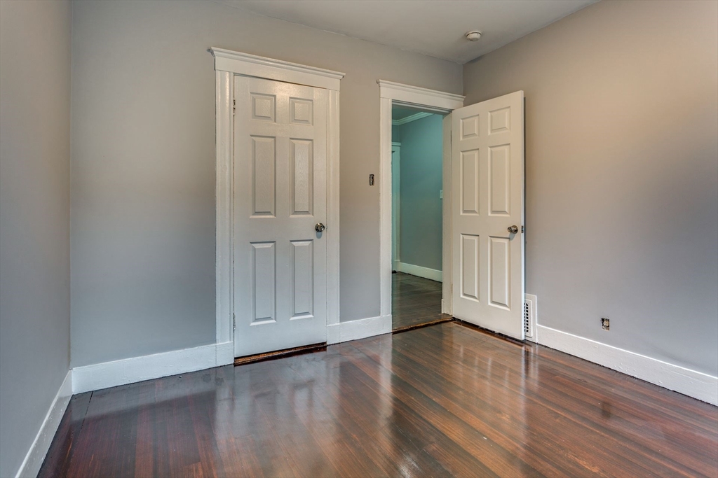 10 Winter Street, Unit 3 Boston, MA 02110 - Photo 5 of 7 a view of an empty room with wooden floor